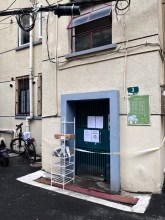 A building sealed in Pak's apartment complex.  A stand was set up outside the door for residents to retrieve their deliveries. (Jennifer Pak/Marketplace)