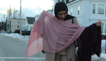 Israa Enan holds up a pink hijab.