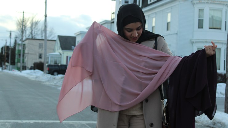 Israa Enan holds up a pink hijab.