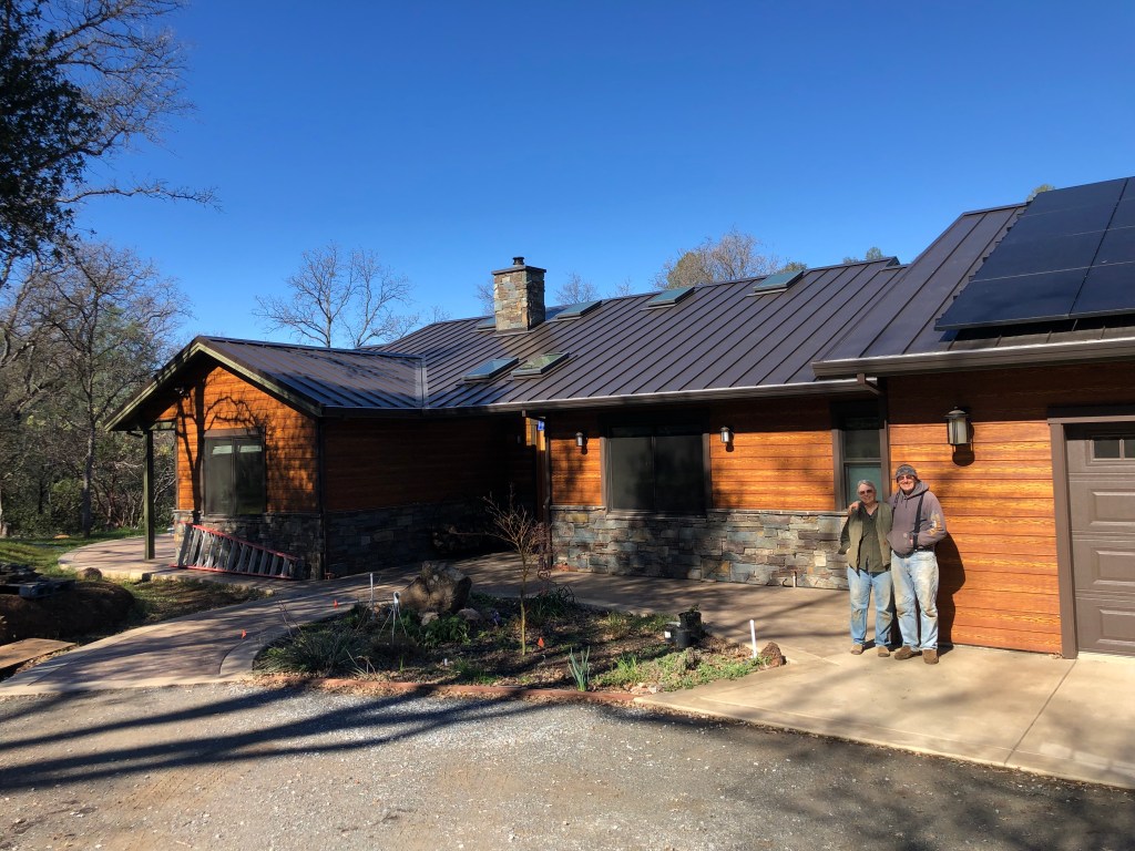 Ann and Jim Pesout in front of their new house in Calaveras County, California.