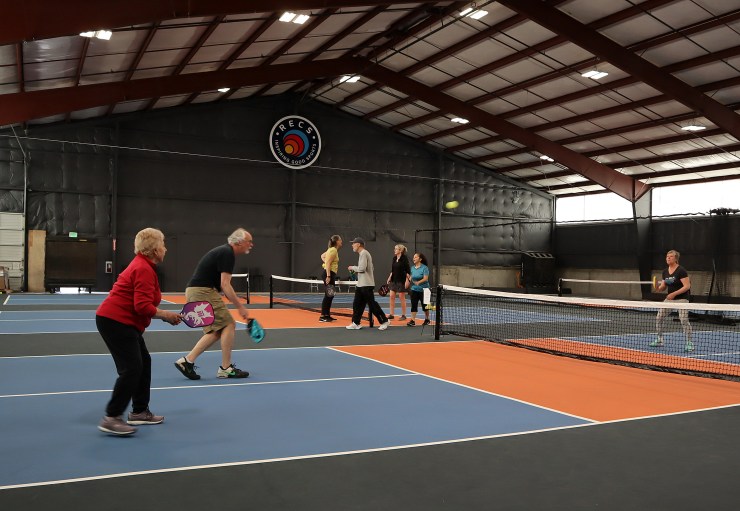 Pickleball enthusiasts practice and take classes 