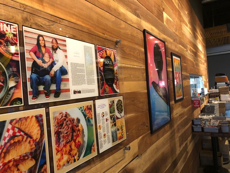 Photo of a special wall at Boricua Soul with articles about the restaurant. 