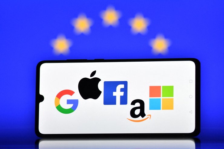 An illustration picture shows the logos of Google, Apple, Facebook, Amazon and Microsoft displayed on a mobile phone with an European Union flag displayed in the background