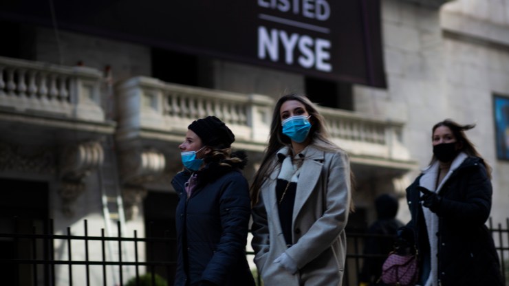 Women walk past the New York Stock Exchange (NYSE) near Wall Street in New York on February 8, 2021.