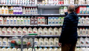 A shopper walks through the dairy aisle of a grocery store in Washington, D.C.