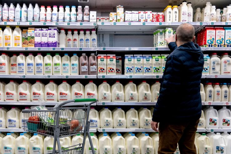 A shopper walks through the dairy aisle of a grocery store in Washington, D.C.