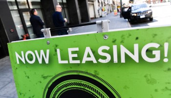 A 'now leasing' sign is displayed outside of an apartment building on March 11, 2022 in downtown Los Angeles, California.