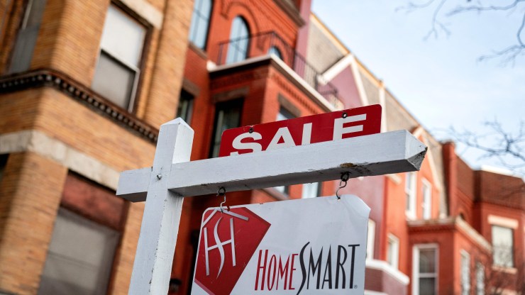 A For Sale sign is displayed in front of a house in Washington, DC, on March 14, 2022.