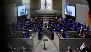 Members of the German government and Ukrainian President Volodymyr Zelenskyy appearing on a screen are reflected as he addresses via videolink the German lower house of parliament Bundestag, on March 17, 2022 in Berlin.