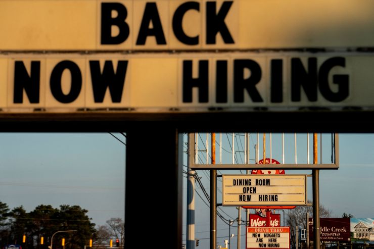 A "Now Hiring" sign in front of a restaurant in Rehoboth Beach, Delaware, in March.
