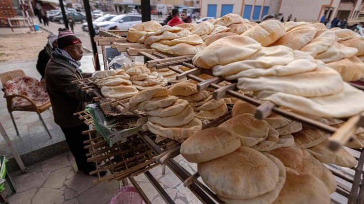 A man sells bread at a bakery in Egypt.