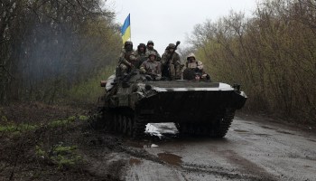 Ukrainian soldiers stand on an armoured personnel carrier (APC), not far from the front-line with Russian troops, in Izyum district, Kharkiv region on April 18, 2022, during the Russian invasion of Ukraine.