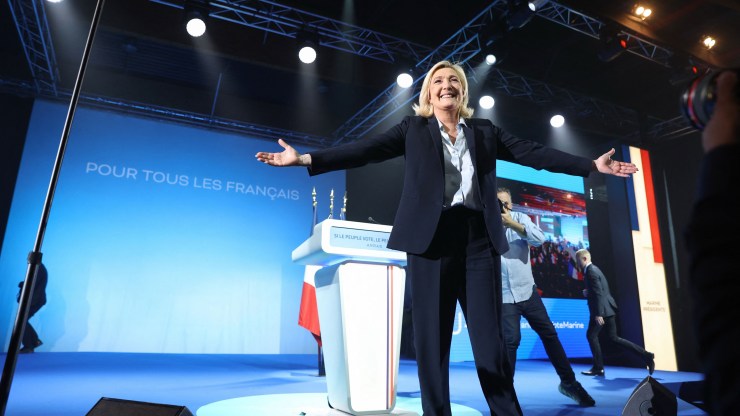 French far-right party Rassemblement National (RN) presidential candidate Marine Le Pen arrives on stage during an election campaign meeting in Arras, northern France, on April 21, 2022, ahead of the second round of France's presidential election