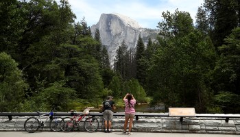 Visitors take pictures of Half Dome on June 11, 2020 in Yosemite National Park, California. .