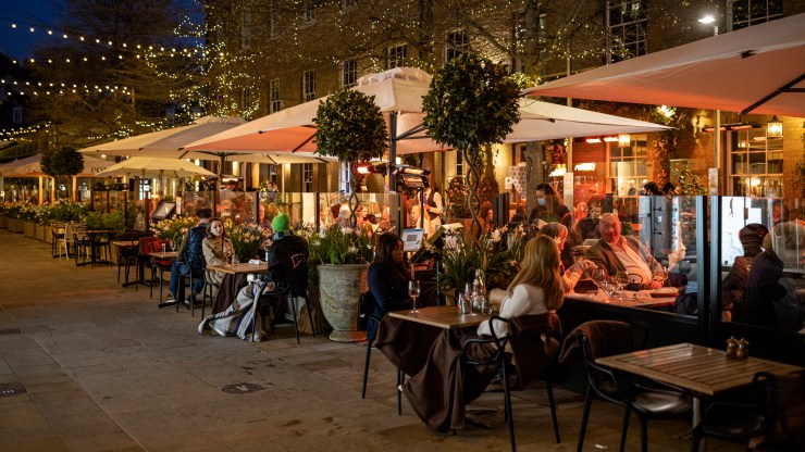 Diners eating outdoors at a London restaurant in April 2021.