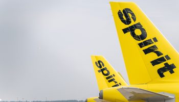 "Spirit" is written across the yellow tail of an airplane.