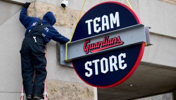 Workers put up Cleveland Guardians signage at Progressive Field in November 2021.