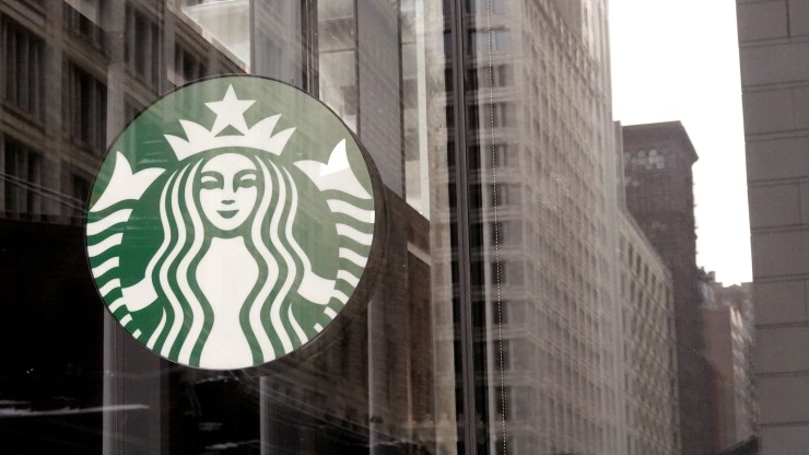 A Starbucks logo hangs in the window of one of the chain's coffee shops in the Loop on January 4, 2022 in Chicago, Illinois.