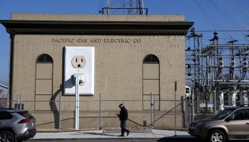 A pedestrian walks by a PG&E electrical substation on January 26, 2022 in Petaluma, California.