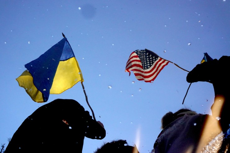 Demonstrators are reflected in a puddle of melted snow during a rally in support of Ukraine in Chicago's Ukrainian Village in February.