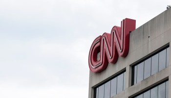 People walk by the world headquarters for the Cable News Network (CNN) on March 15, 2022 in Atlanta, Georgia.