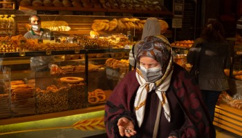 A woman buys bread from a bakery on March 23, 2022 in Istanbul, Turkey.
