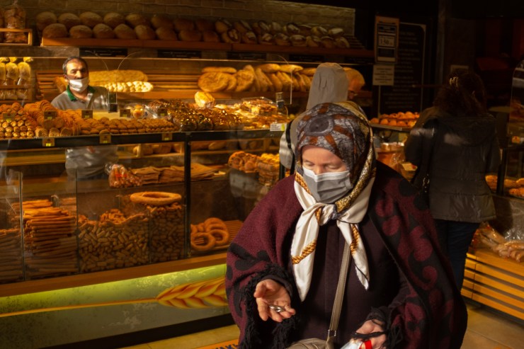 A woman buys bread from a bakery on March 23, 2022 in Istanbul, Turkey.