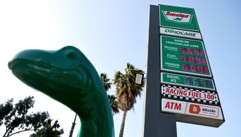 Gas prices are displayed at a Sinclair station on April 27, 2022 in Burbank, California behind a Sinclair dinosaur..