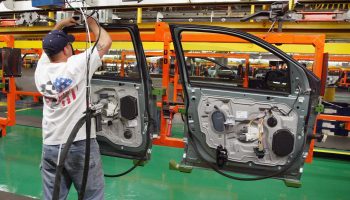 A worker assembles car door units at Ford's Chicago Assembly Plant in 2004.