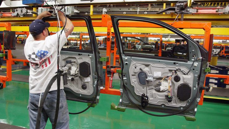A worker assembles car door units at Ford's Chicago Assembly Plant in 2004.