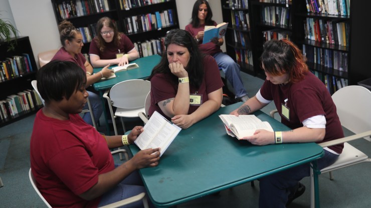 Prison inmates read in the library of the York Community Reintegration Center on May 24, 2016 in Niantic, Connecticut.