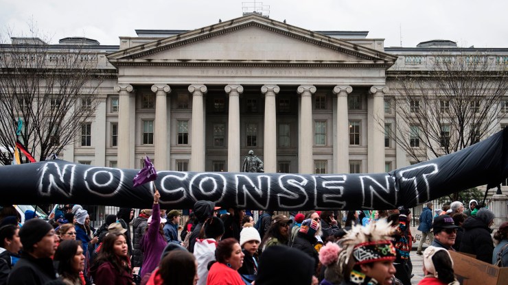 Activists rallying for Native American rights march past the US Treasury Department during the Native Nations Rise protest March 10, 2017.