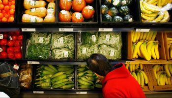 A shopper selects from pre-packaged produce at a grocery store in Los Angeles, California.