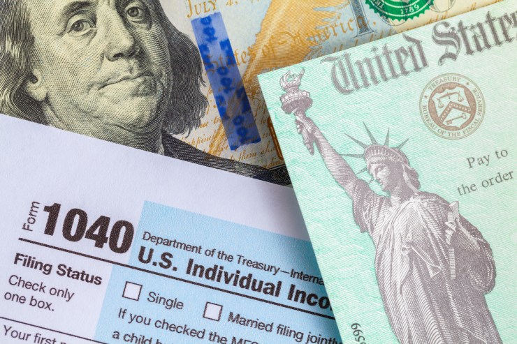 IRS Form 1040 with tax check and money.