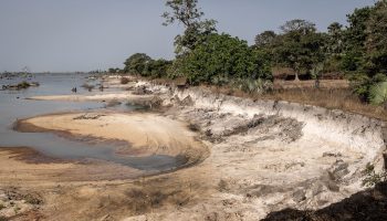 A tract of sand is eaten out of the Gambian coast from mining.