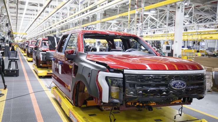 A red Ford truck on an assembly line.
