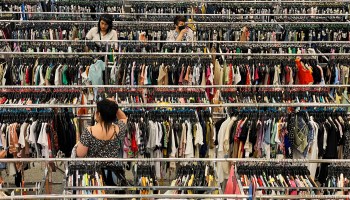 Customers browse racks of clothing as they shop inside a discount department retail store in Las Vegas, Nevada, on May 7, 2022.