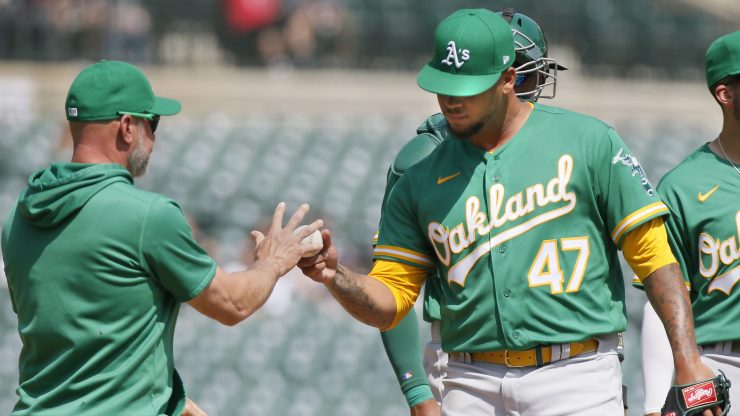 Oakland A's player and manager on the field during a game.
