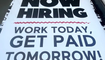 Sign that reads "NOW HIRING WORK TODAY, GET PAID TOMORROW!"