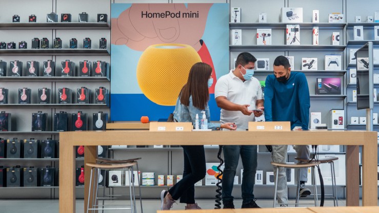 An Apple store employee serves customers in Houston.