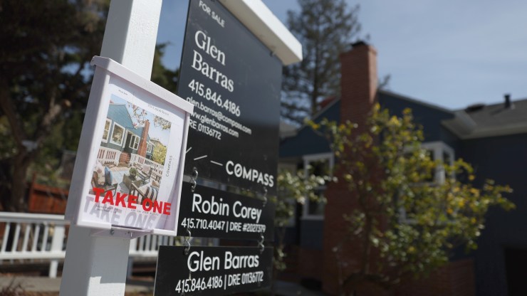A for sale sign is posted in front of a home in March in San Rafael, California.