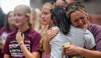 Girls embrace and mourn at Robb Elementary School in Uvalde, Texas.