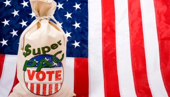 A sack of what appears to be voting ballots is stamped with the words "Super PAC" in front of the American flag.