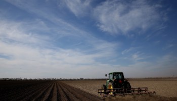 A tractor plows a field on February 25, 2014, in Firebaugh, California.