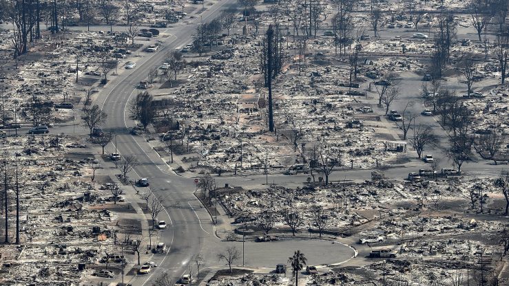 Aerial view of a burned-down neighborhood in California, with houses reduced to ash.