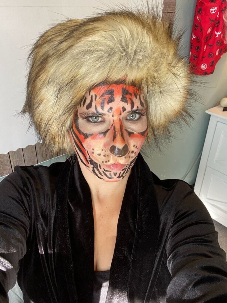 Teacher Caroline Kuhlman O'Neill with a fur hat and makeup to look like a tiger.