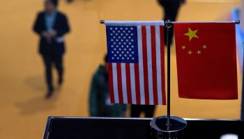A miniature U.S. and Chinese flag are seen side-by-side.