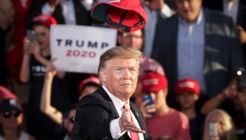 Then-President Donald Trump tosses a hat into a crowd at a rally in Pennsylvania in 2019.