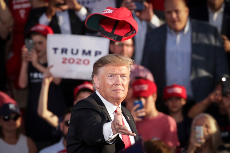 Then-President Donald Trump tosses a hat into a crowd at a rally in Pennsylvania in 2019.
