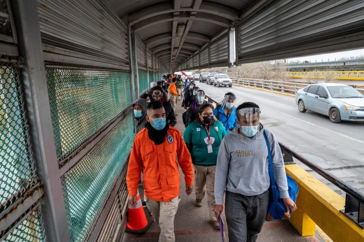 Migrants approach the U.S. border on Gateway International Bridge in Brownsville, Texas on March 2, 2021. President Biden announced that he was ending the Migrant Protection Protocol (MPP) enacted under President Trump that sent asylum seekers back to Mexico as they awaited their trial dates.